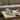 Bonbonniere grøn/lys mint fra EJA på sofabord med kaffe og bog